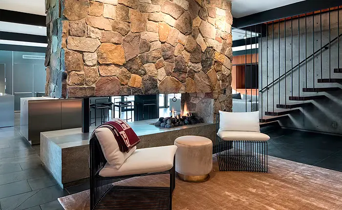 Stone-clad fireplace creates the perfect focal point for this La Canada Mid Century Modern home.