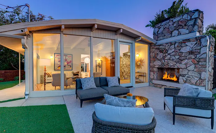 Outdoor patio with fireplace of a Mid Century Modern Hollywood Hills home