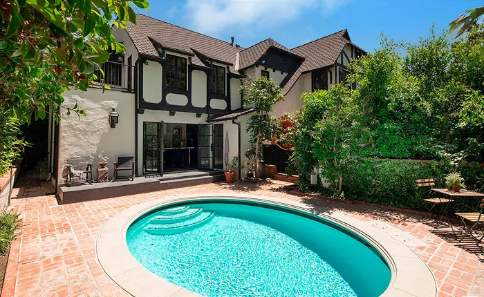 This outdoor retreat, meticulously landscaped and laden with blooming flowers and lush greenery, is not merely an extension of this Los Feliz English Tudor home, but a haven of tranquility.