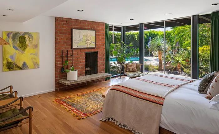 Bedroom with fireplace of a Los Feliz Edward Fickett Home.