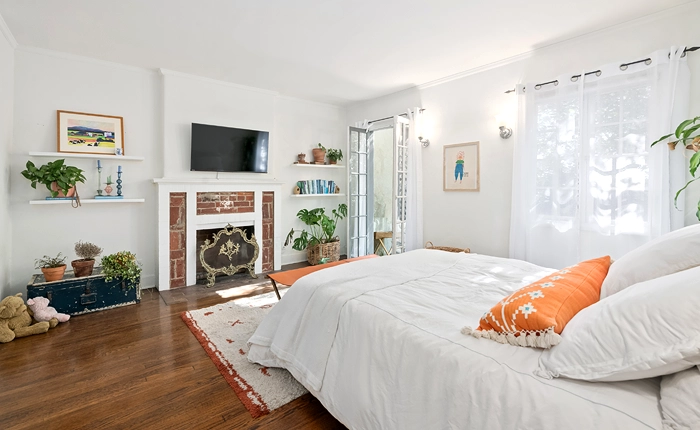 The bedroom of this Beachwood Canyon English Tudor duplex opens to the lush garden