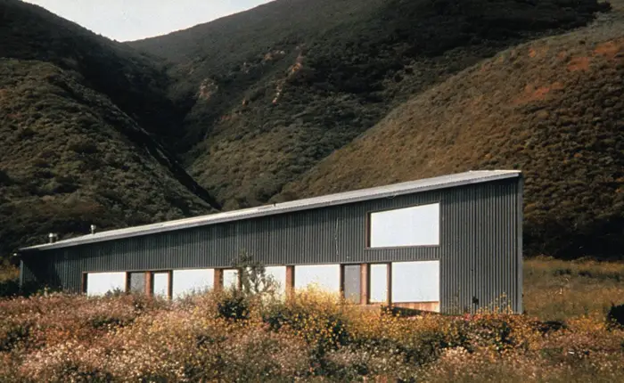 The Davis House and Studio in Malibu, a trapezoidal corrugated metal structure on a pastoral hillside